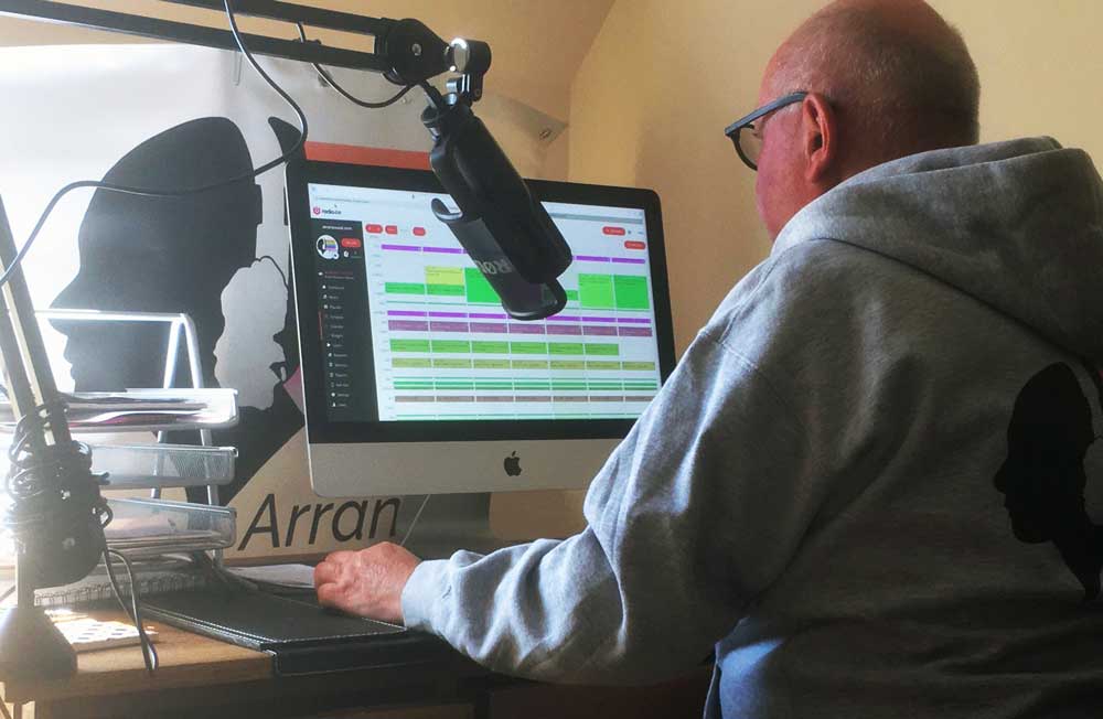 Picture shows an Arran Sound volunteer broadcasting from their home studio.